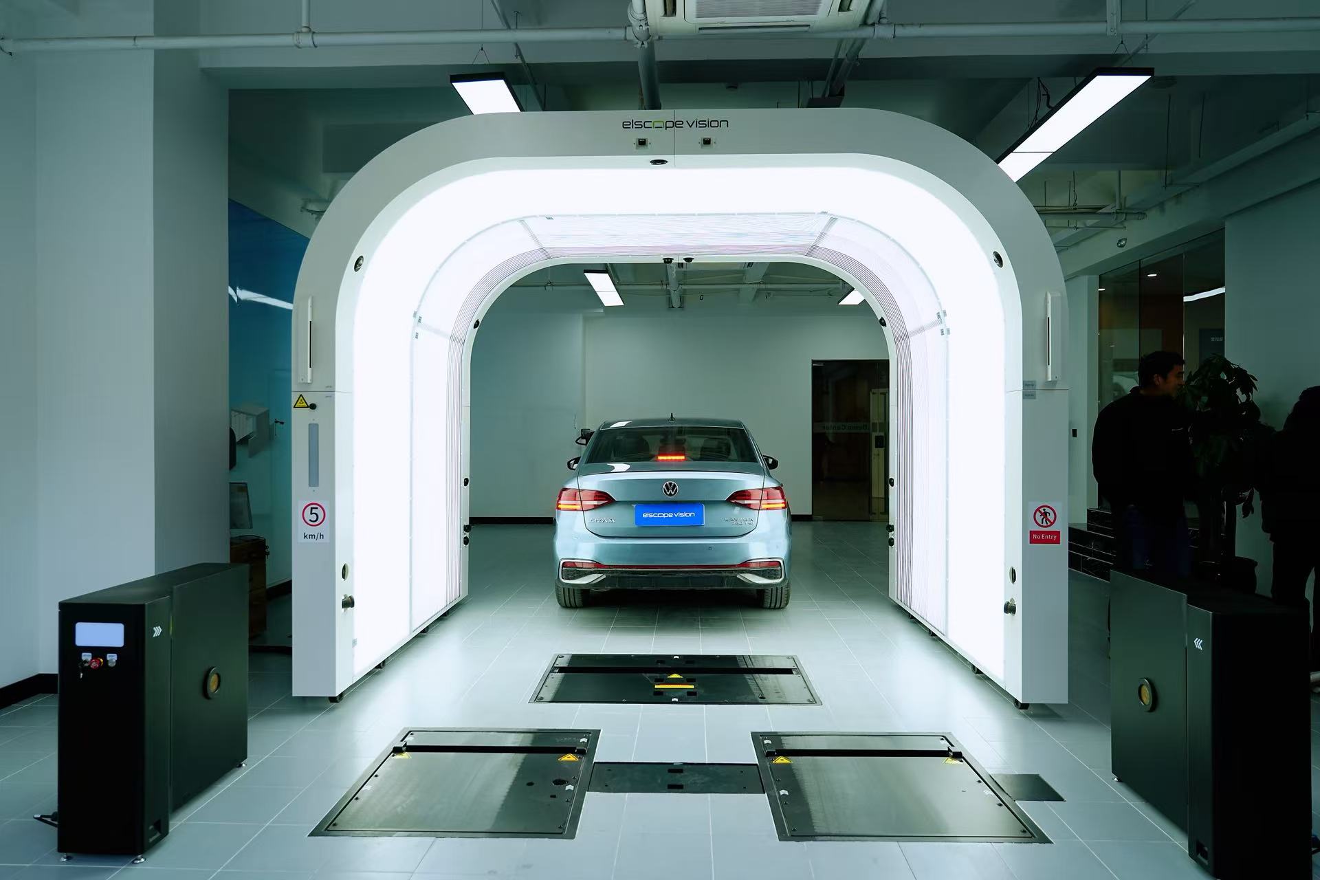 Passenger car passing through an Elscope Vision drive-through scanner for consistent image capture.