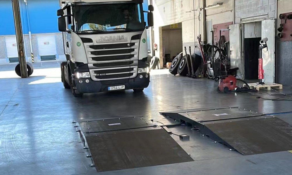 Heavy-duty fleet vehicles lined up for automated inspection.