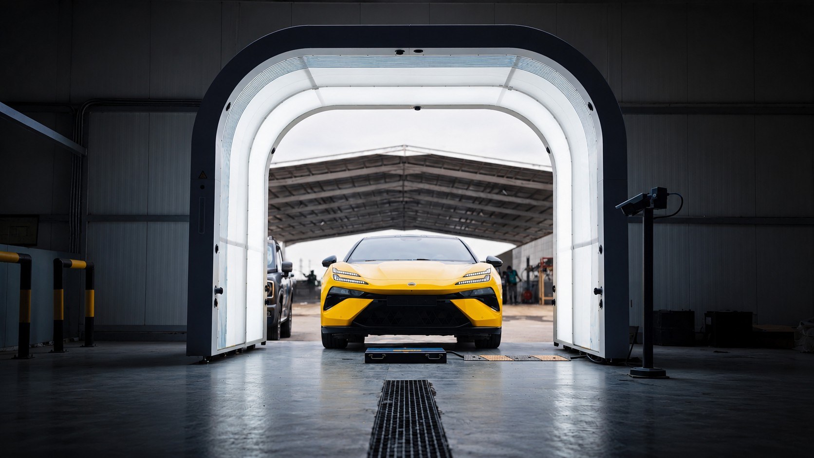 Passenger vehicle positioned beneath an Elscope Vision inspection arch with drive-over modules