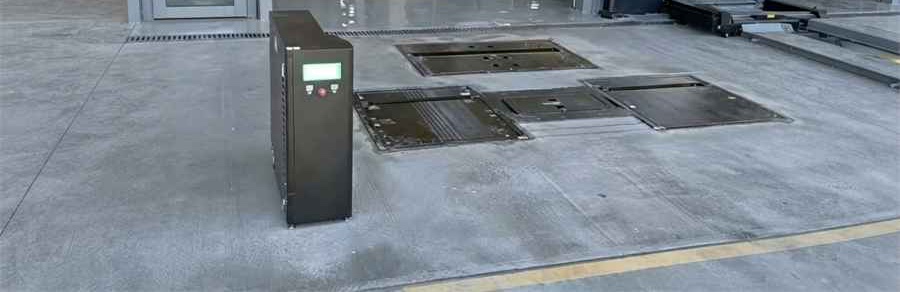 Floor-mounted tire tread and underbody scanning plates with a control cabinet at an inspection station